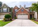 Charming exterior view of townhome with attached garage and well-maintained landscaping at 238 Lynchwick Ln, Durham, NC 27703