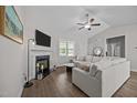Comfortable living room with a fireplace, hardwood floors, and neutral-toned furniture at 244 Lasswade Ct, Zebulon, NC 27597