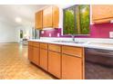 A kitchen featuring wooden cabinets, white countertops, and purple-painted walls at 252 Fox Ridge, Pittsboro, NC 27312