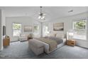 Spacious main bedroom with a vaulted ceiling, plush carpeting, and abundant natural light at 2621 Asher View Ct, Raleigh, NC 27606
