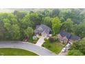 Lovely home surrounded by lush greenery, mature trees, and a well-manicured lawn in an attractive neighborhood at 3024 Weston Ct, Burlington, NC 27215