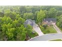 Beautiful house surrounded by mature trees, creating privacy, with a circular driveway in a great neighborhood at 3024 Weston Ct, Burlington, NC 27215