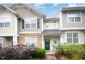 Charming townhome featuring manicured landscaping and inviting green front door at 3519 Sugar Tree Pl, Durham, NC 27713