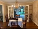 Dining room with chandelier and views to backyard through open french doors at 3604 Woodlawn Rd, Rocky Mount, NC 27804