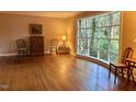 Light-filled living room featuring hardwood floors, a large window, and classic decor at 3604 Woodlawn Rd, Rocky Mount, NC 27804