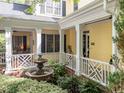 Enchanting courtyard with a fountain, lush greenery, and covered porch offering a peaceful outdoor retreat at 4001 Falls River Ave, Raleigh, NC 27614