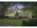 Beautiful two-story home with a welcoming porch, manicured landscaping, and mature trees, offering charm and curb appeal at 4001 Falls River Ave, Raleigh, NC 27614