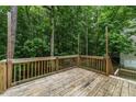 Spacious wooden deck offering a serene view of the surrounding trees at 412 Hay River St, Garner, NC 27529