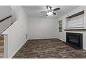 Cozy living room featuring wood-look floors, fireplace, and abundant natural light at 412 Hay River St, Garner, NC 27529