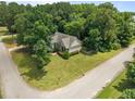 An aerial view of the residence shows the home's placement on a tree-lined corner lot at 44 Supreme Dr, Lillington, NC 27546