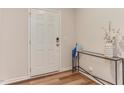 Inviting entryway features a stylish console table, white door, and wood-look flooring at 474 Carolina Springs Dr, Apex, NC 27539