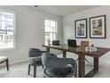 Bright home office with gray chairs, natural light, and a dark wood desk at 474 Carolina Springs Dr, Apex, NC 27539