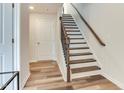 Hallway features a staircase with white risers, wood treads, and an iron-balustrade railing at 474 Carolina Springs Dr, Apex, NC 27539