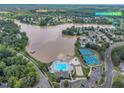 Aerial view of the lake community with pool, tennis courts and address of the home at 503 Bellmeade Bay Dr, Durham, NC 27703