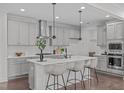 Modern kitchen with a large island, stainless steel appliances, and stylish pendant lighting at 520 Flip Trl, Cary, NC 27513