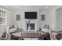 Inviting living room featuring a fireplace, comfortable seating, and modern decor at 520 Flip Trl, Cary, NC 27513