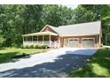 Charming brick home featuring a two-car garage and well-maintained gravel driveway at 5464 Bass Mountain Rd, Snow Camp, NC 27349