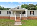 Inviting front porch with white railings and brick steps, perfect for relaxing outdoors at 558 Christys Way, Roxboro, NC 27574