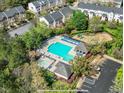 Aerial view of community pool and playground featuring lounge chairs, tables, and a well-maintained area at 5717 Corbon Crest Ln, Raleigh, NC 27612