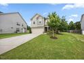 Attractive front yard featuring a lush green lawn, mature trees, and manicured landscaping enhancing the curb appeal at 601 Richlands Cliff Dr, Youngsville, NC 27596