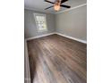 Bright bedroom featuring a ceiling fan, neutral walls, hardwood floors and a window at 603 S Third St, Mebane, NC 27302