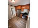 Updated kitchen with wooden cabinets, stainless steel appliances, and modern finishes at 603 S Third St, Mebane, NC 27302