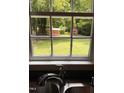 Kitchen sink looking out the window to the nice, big, green, and private backyard at 603 S Third St, Mebane, NC 27302