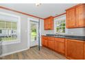 Cozy kitchen featuring warm wood cabinetry, neutral countertops and views of the backyard at 603 S Third St, Mebane, NC 27302