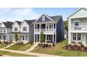 Charming home features a double porch, manicured lawn, and is close to other similarly styled houses at 627 Georgias Landing Pkwy, Raleigh, NC 27603