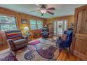 Comfortable living room with natural light, three armchairs, and unique rug at 6305 Holly Ridge Rd, Rougemont, NC 27572