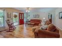 Inviting living room with a red front door, rocking chair, and cozy furniture at 6305 Holly Ridge Rd, Rougemont, NC 27572