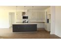 Bright kitchen featuring an island with bar seating, stainless appliances, and ample counter space at 70 Basil Ct, Franklinton, NC 27525