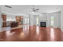 Open-concept living room featuring hardwood floors, fireplace, and seamless access to the kitchen at 760 Stackhurst Way, Wake Forest, NC 27587