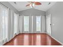 Bright sunroom with hardwood floors, ceiling fan, and abundant natural light through large windows at 760 Stackhurst Way, Wake Forest, NC 27587