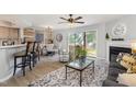 Bright living room with a fireplace, sliding glass doors, and an open layout to the dining area at 7708 Falcon Rest Cir, Raleigh, NC 27615