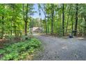 Long, secluded driveway leads to this home surrounded by a lush forest at 8226 Mcarthur Park Dr, Efland, NC 27243