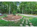 Tranquil front yard with stone pathway and a landscaped island for outdoor enjoyment at 8226 Mcarthur Park Dr, Efland, NC 27243