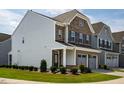 Side view of a two-story home with brick and vinyl siding, showcasing the well-kept landscaping at 1018 Excite Ave, Morrisville, NC 27560
