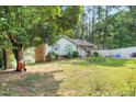Landscaped front yard with a traditional home featuring brick accents and a tidy lawn at 106 Lattimore Ln, Durham, NC 27713