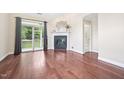 Bright living room with hardwood floors, fireplace, and sliding door access to the outside at 1090 Indigo Ridge Pl, Cary, NC 27519