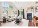 Cozy living room with vaulted ceilings, fireplace, and plenty of natural light at 1090 Indigo Ridge Pl, Cary, NC 27519