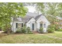 Charming home exterior with lush green lawn and mature trees, a delightful neighborhood setting at 1104 Englewood Ave, Durham, NC 27701