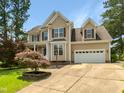 Lovely two-story home featuring an attached garage and well-maintained front yard at 1201 Dagmar Ln, Wake Forest, NC 27587