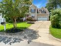 Desirable two-story home with a driveway and mature landscaping in a friendly neighborhood at 1201 Dagmar Ln, Wake Forest, NC 27587