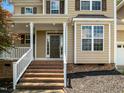 Inviting front entrance with brick steps, white railing, and covered porch at 1201 Dagmar Ln, Wake Forest, NC 27587