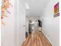 Bright hallway featuring wood flooring and a view of the living area at 128 Palmdale Ct, Holly Springs, NC 27540