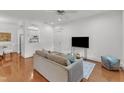 Inviting living room featuring hardwood floors, a comfortable couch, and a view into the adjacent kitchen area at 1310 Durlain Dv # 103, Raleigh, NC 27614