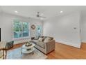 Bright living room with hardwood floors, ceiling fan, large windows, and modern decor at 1310 Durlain Dv # 103, Raleigh, NC 27614