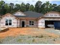New home construction featuring an attached two-car garage and a spacious front yard at 148 Merrifield Ln # 128, Garner, NC 27529