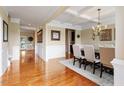 Elegant dining room with hardwood floors, coffered ceiling, and wainscoting details at 150 Saint Mellion St, Raleigh, NC 27603